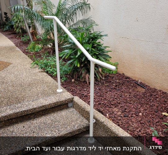 מעקה מתכת לבן על מדרגות חיצוניות